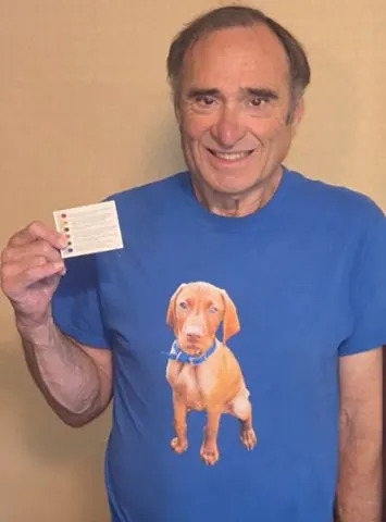 Courtesy Laurence Canter  Canter holding a Trivia Pursuit card that references his connection to spam.