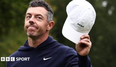 Rory McIlroy waves his cap to the crowd after finishing with an eagle three on the par-five 18th at Wentworth on Sunday
