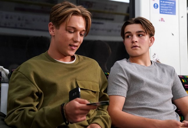 Joel and Tommy sat on the tube in EastEnders