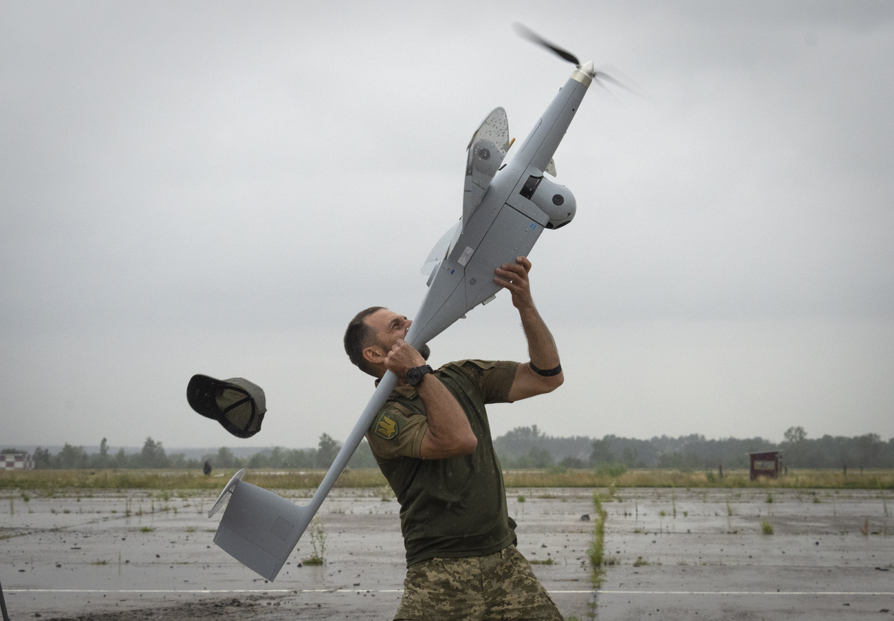 A Ukrainian soldier launches FlyEye WB Electronics SA, a Polish reconnaissance drone, which is in service with the Ukrainian army, in Kyiv region, Ukraine, Tuesday, Aug. 2, 2022.