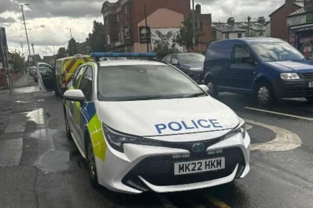Police on Claremont Road, Moss Side, on Monday