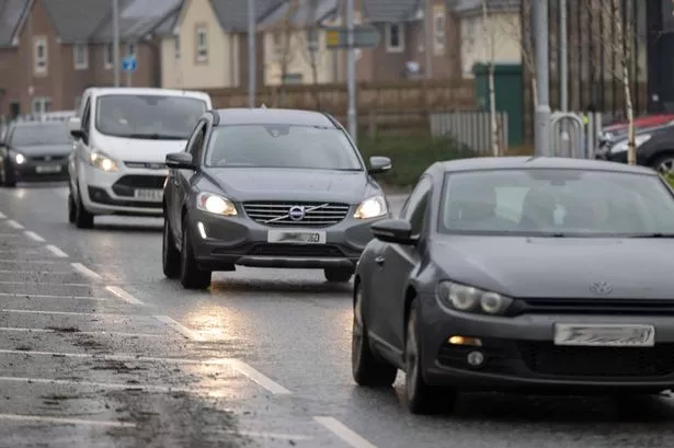 Cars driving down a road, generic