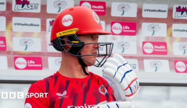 Keaton Jennings sitting in a T20 Blast dugout with his helmet and gloves on
