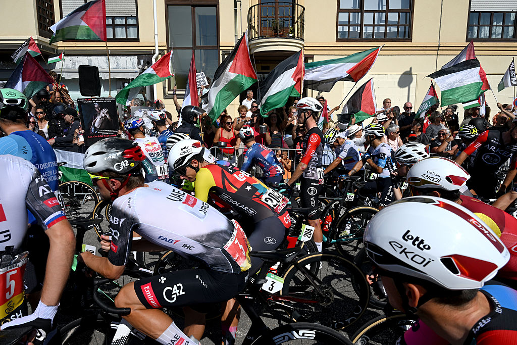 CABEZON DE LA SAL, SPAIN - SEPTEMBER 05: Pro-Palestinian protesters and the Peloton prior to the La Vuelta - 80th Tour of Spain 2025, Stage 13 a 203.7km stage from Cabezon de la Sal to L'Angliru 1556m / #UCIWT / on September 05, 2025 in Cabezon de la Sal, Spain. (Photo by Dario Belingheri/Getty Images)
