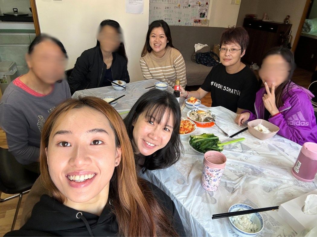 Former homeless women in a co-living apartment share a meal with ImpactHK programme officers. Photo: ImpactHK.