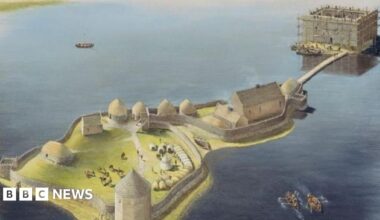 A visualisation showing the previously unknown castle at Finlaggan. It shows two small islands in a loch. The nearest one has thatched roof buildings and a conical-shaped tower. The furthest island has a stone keep and is connected to the other island by a bridge.