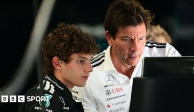 Kimi Antonelli and Mercedes boss Toto Wolff look at a computer screen at Monza