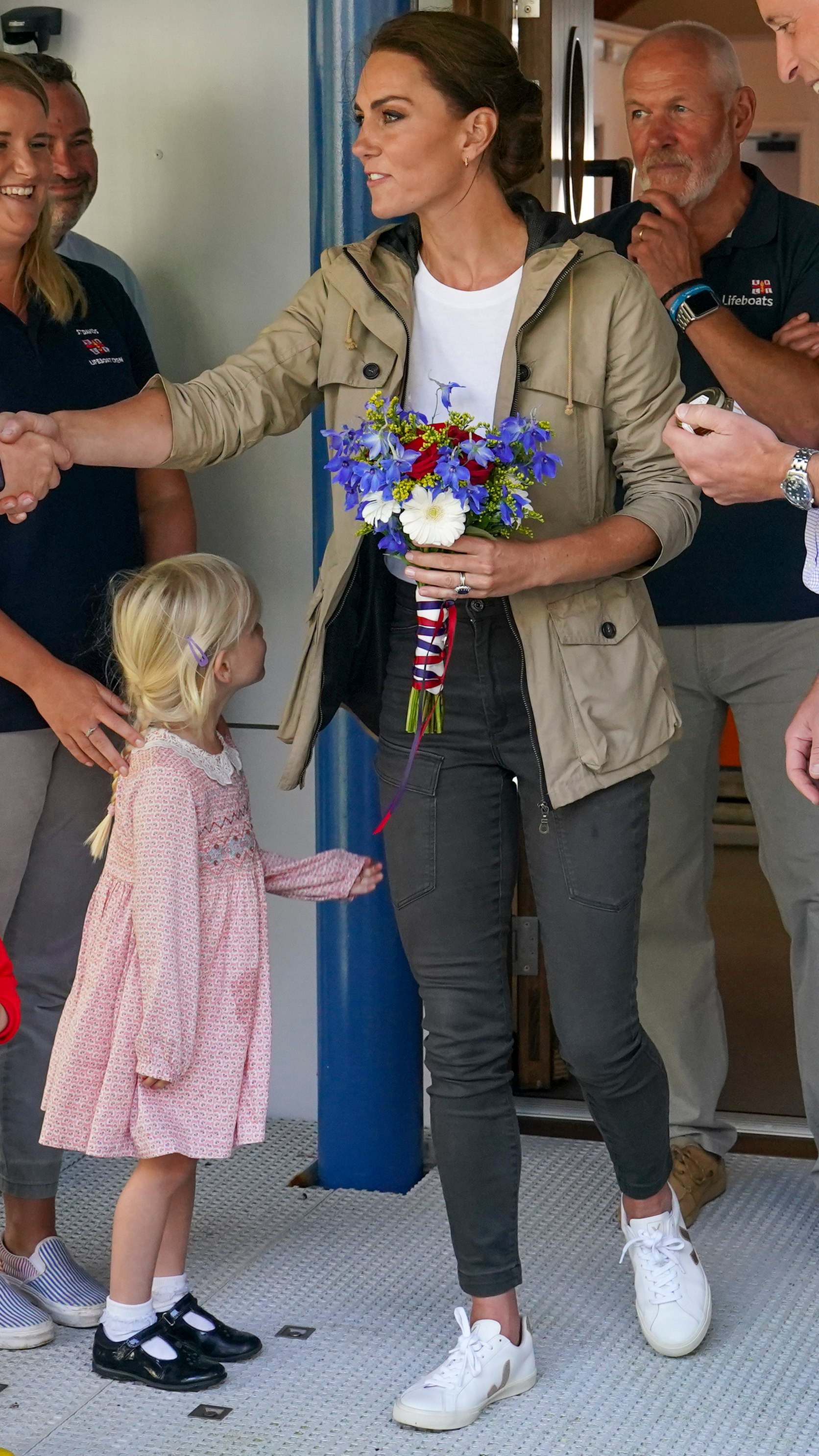 Catherine, Princess of Wales shakes someone's hand as she visits the RNLI LifeBoat Station at St Davids in 2023