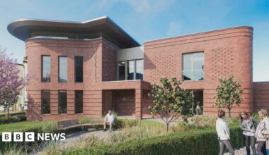 An artist's impression of a modern brown brick two-storey building with a garden area to the front with benches