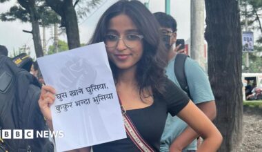 Tanuja Pandey holding a paper showing an anti-corruption slogan during the Gen-Z protests in Nepal