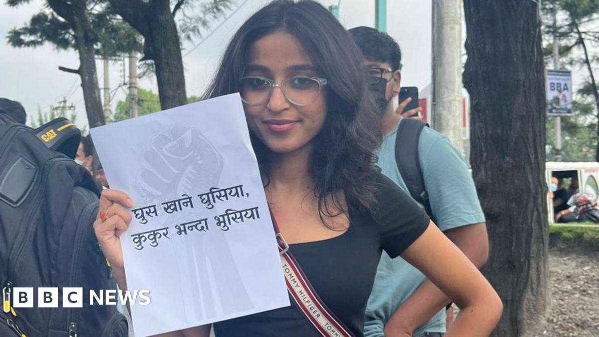 Tanuja Pandey holding a paper showing an anti-corruption slogan during the Gen-Z protests in Nepal