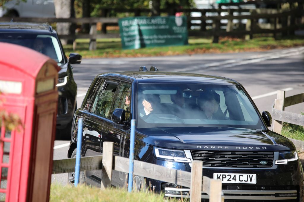 King Charles driving into Crathie