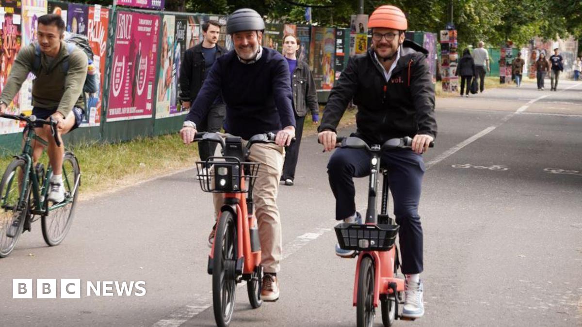 Two cyclists riding towards the camera.