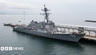 A wide shot of a US Navy warship USS Sampson