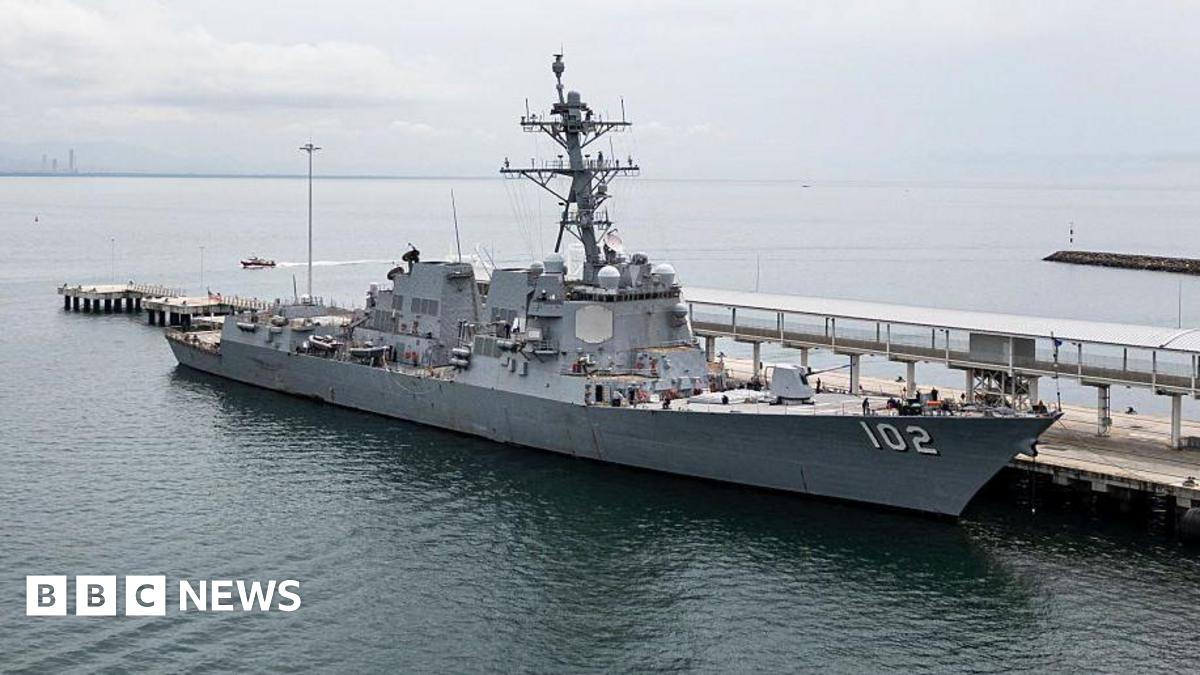 A wide shot of a US Navy warship USS Sampson