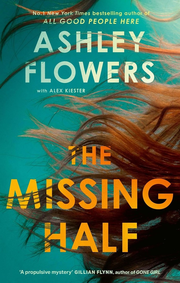 The Missing Half book cover with auburn hair in water