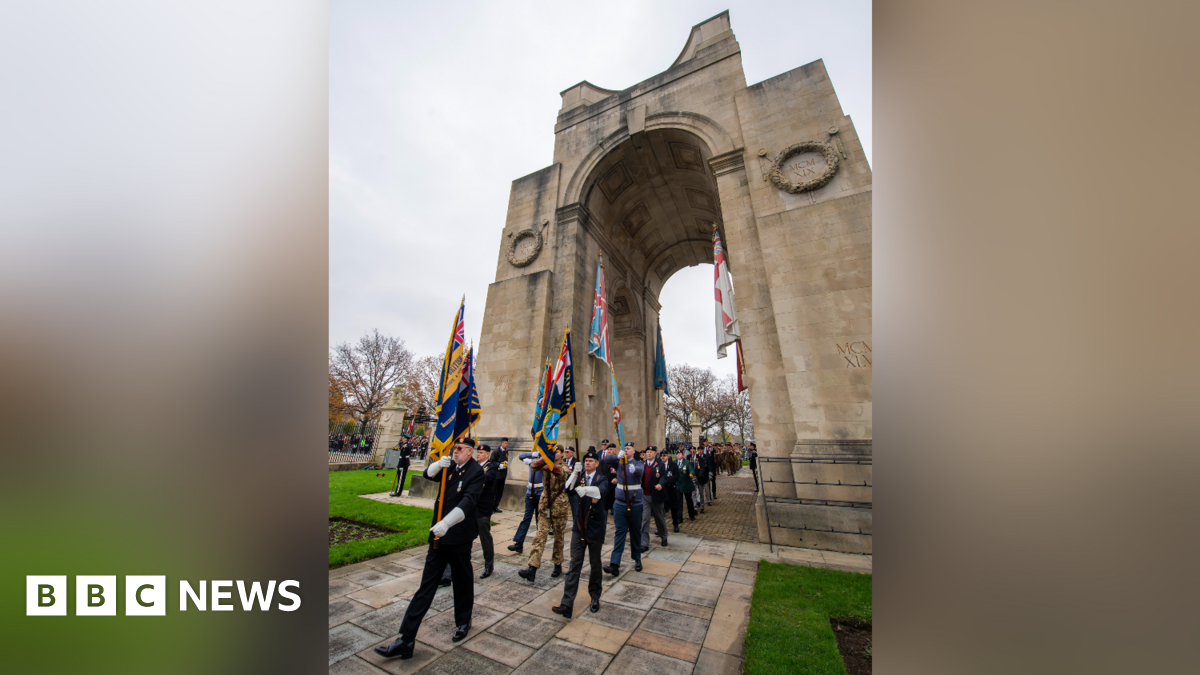 Soldiers and veterans holding flags in front of the Arch of Remembrance in Victoria Park, Leicester, for the Remembrance Sunday service on 9 November 2024.