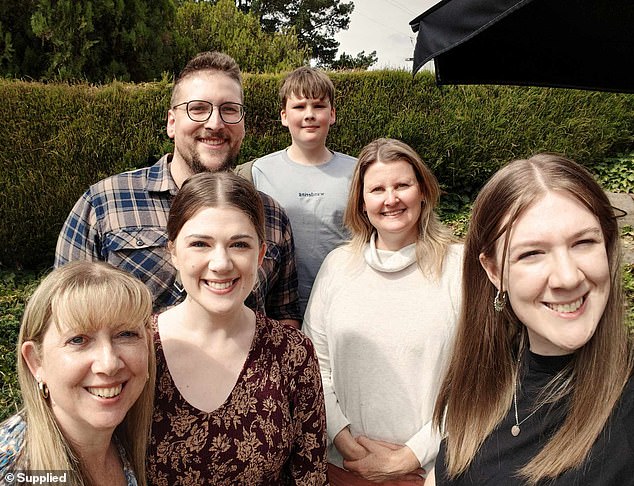 'It is like acid is being poured on your gums while simultaneously having ice cream on your teeth all day - all while they're being smashed with a hammer,' said Emily (pictured with her mother, siblings and husband)