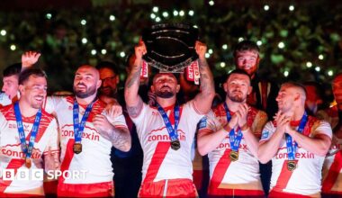 Hull Kingston Rovers captain Elliot Minchella lifts the League Leaders' Shield, surrounded by teammates