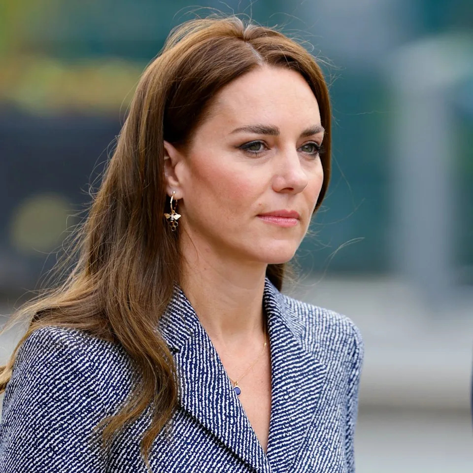  Kate Middleton wears a blue tweed coat dress. 