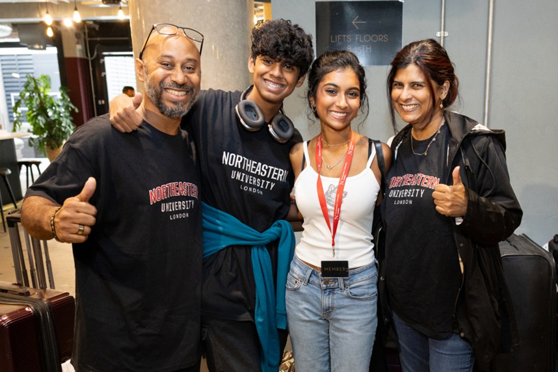A family posing for a photo after helping their student move in.
