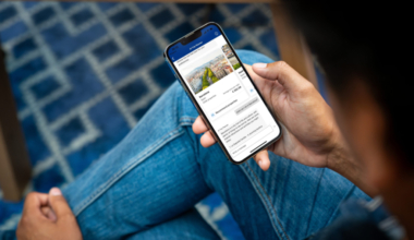 a person holding a phone with the Booking.com app open