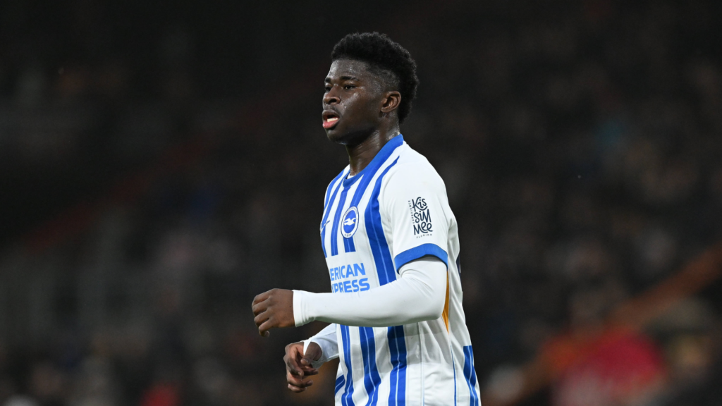 Brighton midfielder Carlos Baleba running with his arms up