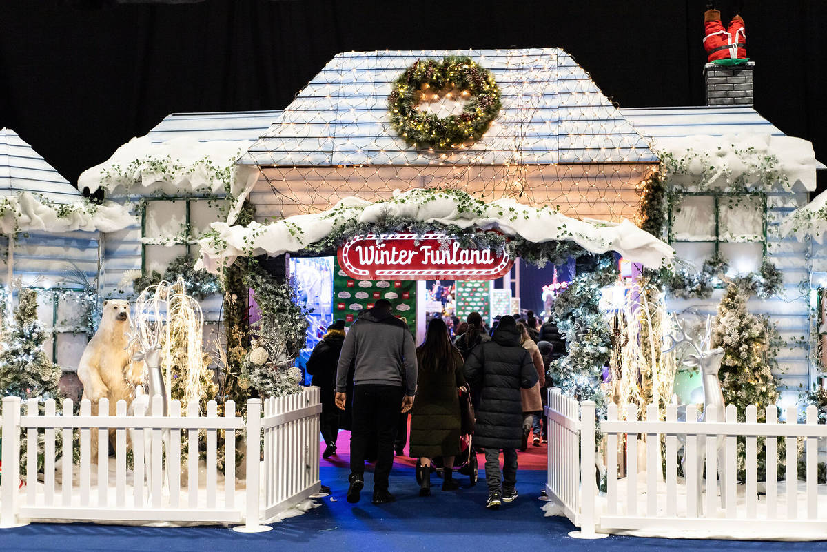 people walking through the entranceway at winter funland