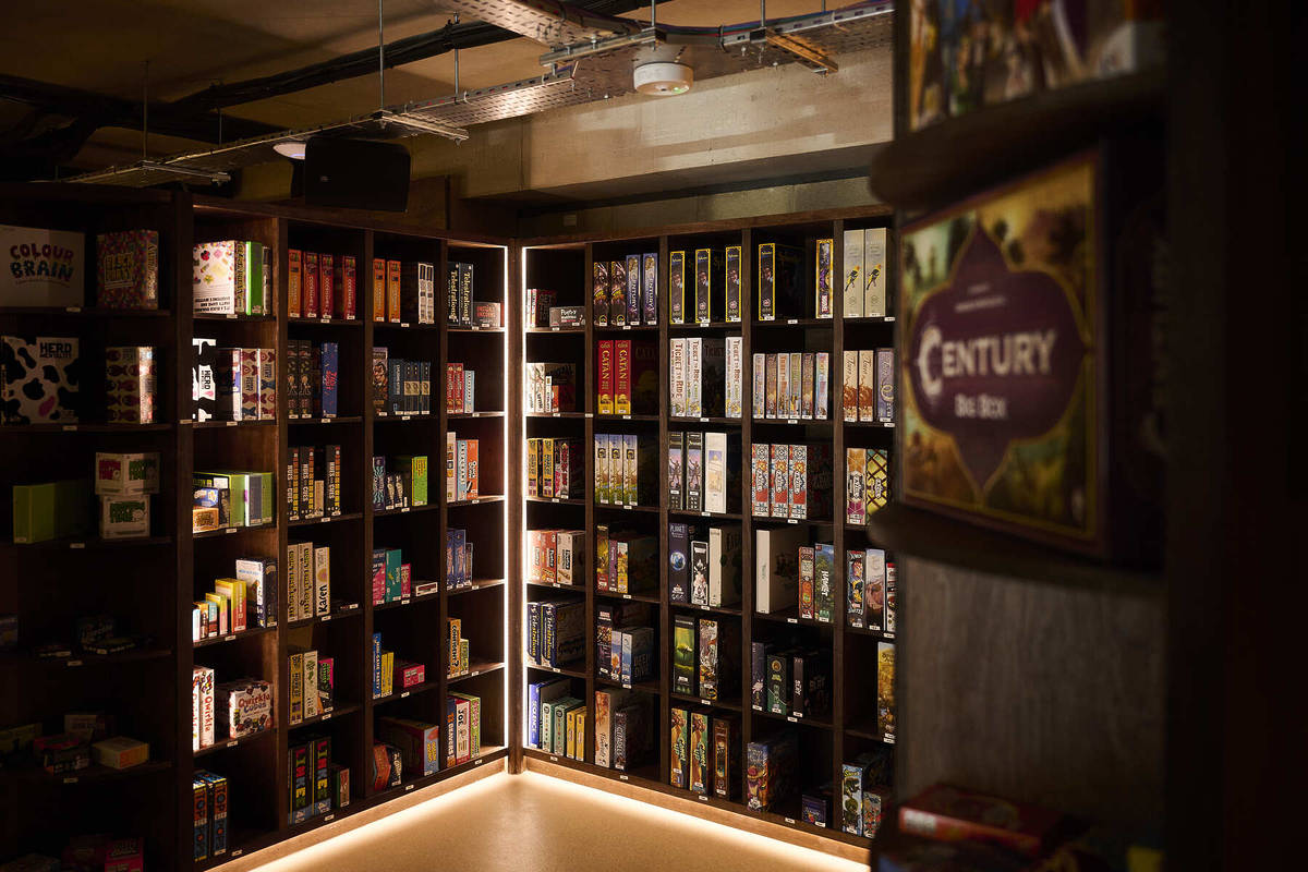 the corner of a room entirely walled with shelving filled with board games