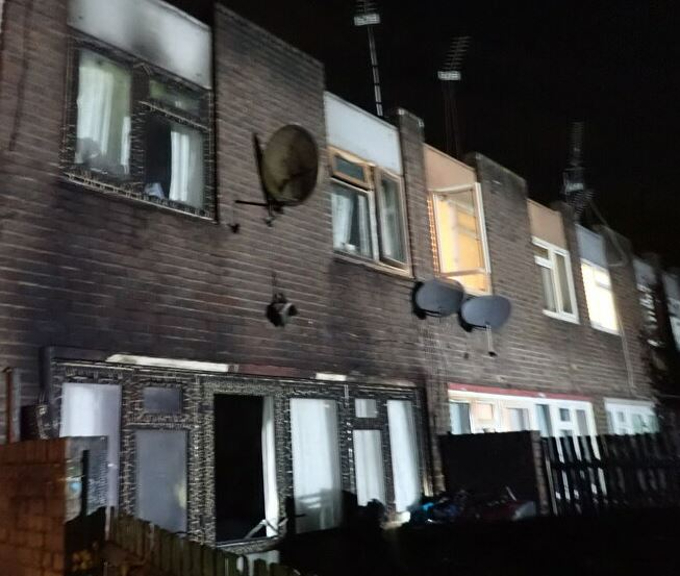 A row of terraced houses in the dark