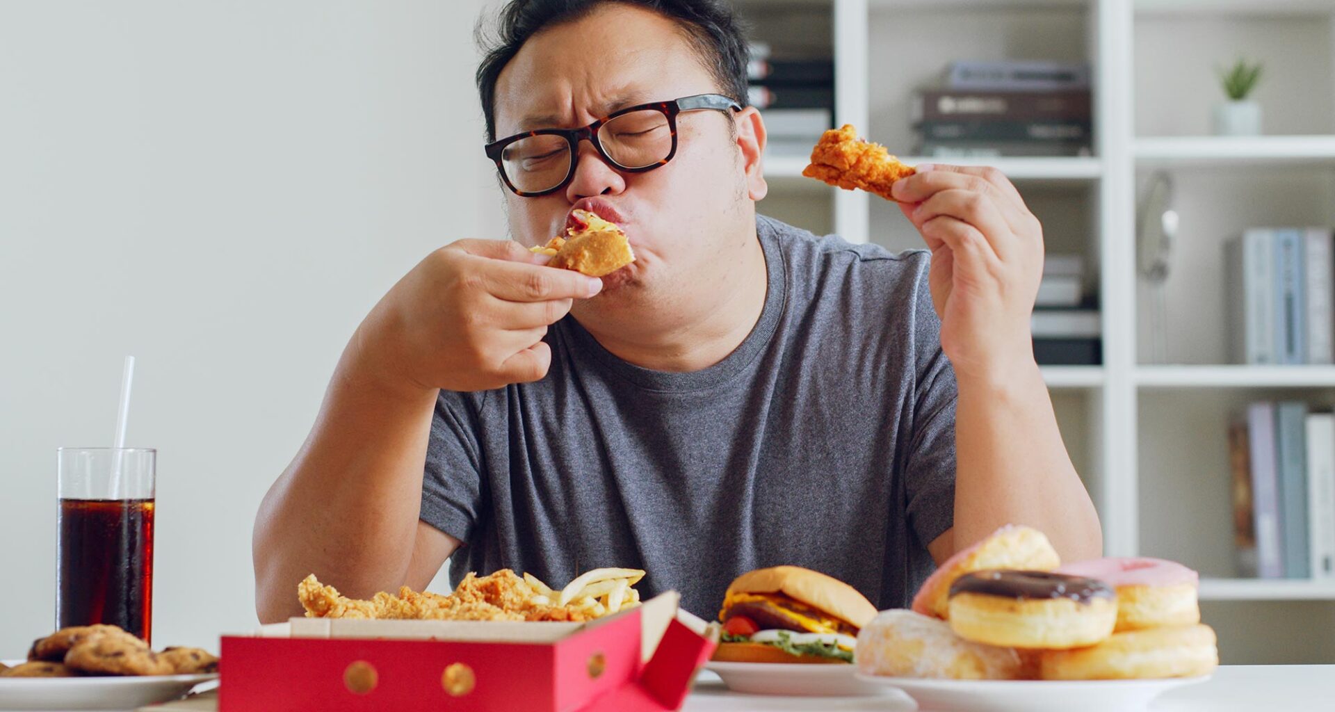 Fat Asian Man Eating Junk Food
