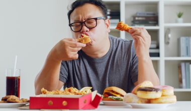 Fat Asian Man Eating Junk Food
