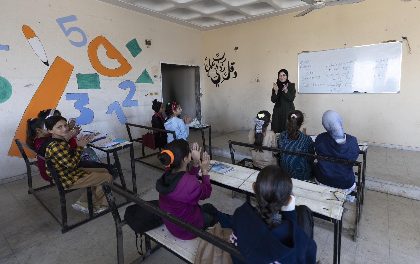 Displaced Palestinian teacher Dina Ukkashi gives courses in the damaged halls of the Islamic University in Gaza Strip in May 2025.