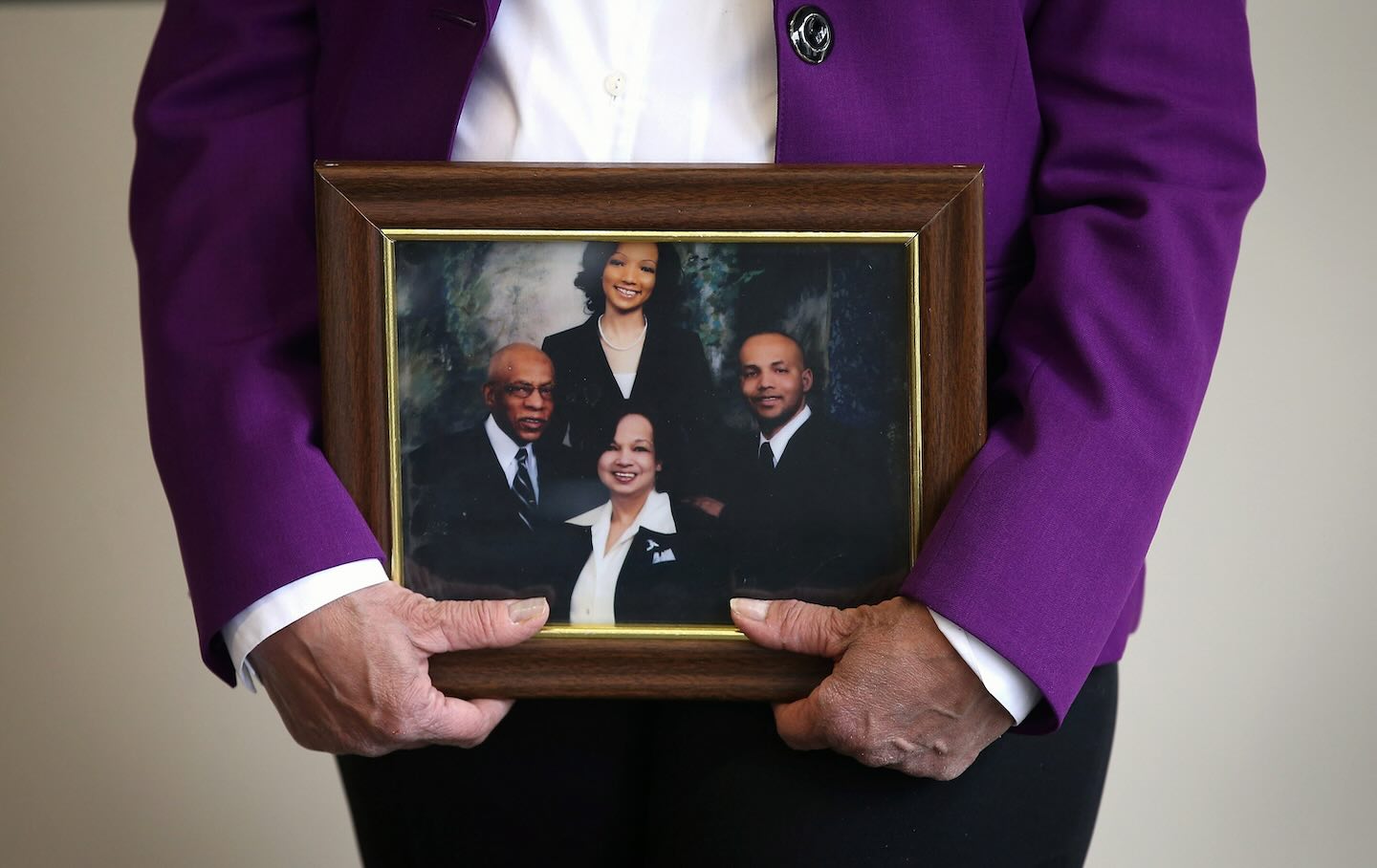 Carolyn Wortham holds a portrait of her family during a press conference on April 24, 2013, in Chicago, Illinois. Worthams’ son, Chicago Police officer and Iraq War veteran Thomas Wortham IV, was killed outside his parents’ home on May 19, 2010, when four reported gang members tried to rob him of his motorcycle.