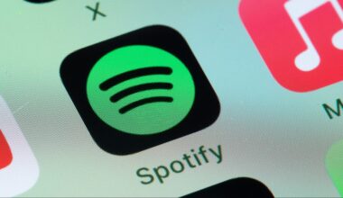 Spotify, Apple Music on smart phone screen.