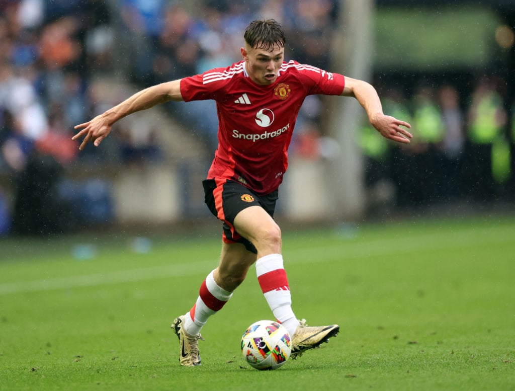 Ethan Ennis runs with the ball for Manchester United