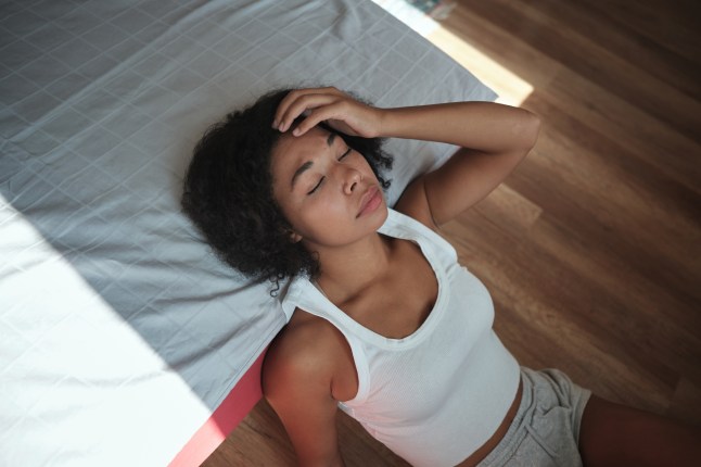 Morning headache. African American woman touching forehead suffering from headache or migraine