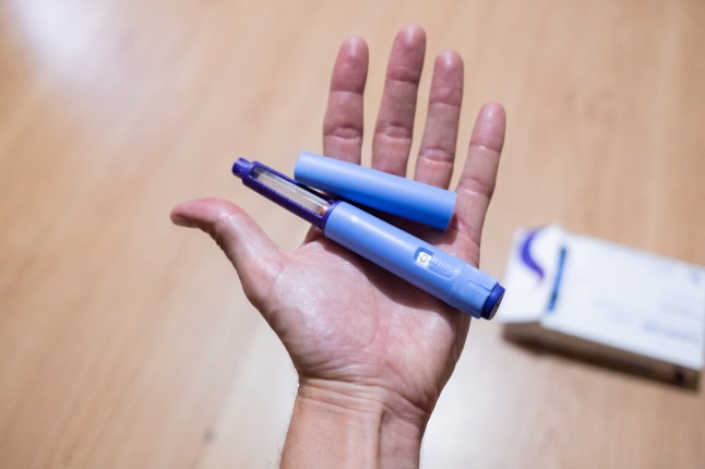 point of view of hand holding semaglutide injection pen as a medical treatment for control the obesity