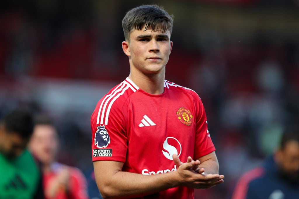 Harry Amass claps at Old Trafford in Manchester United shirt
