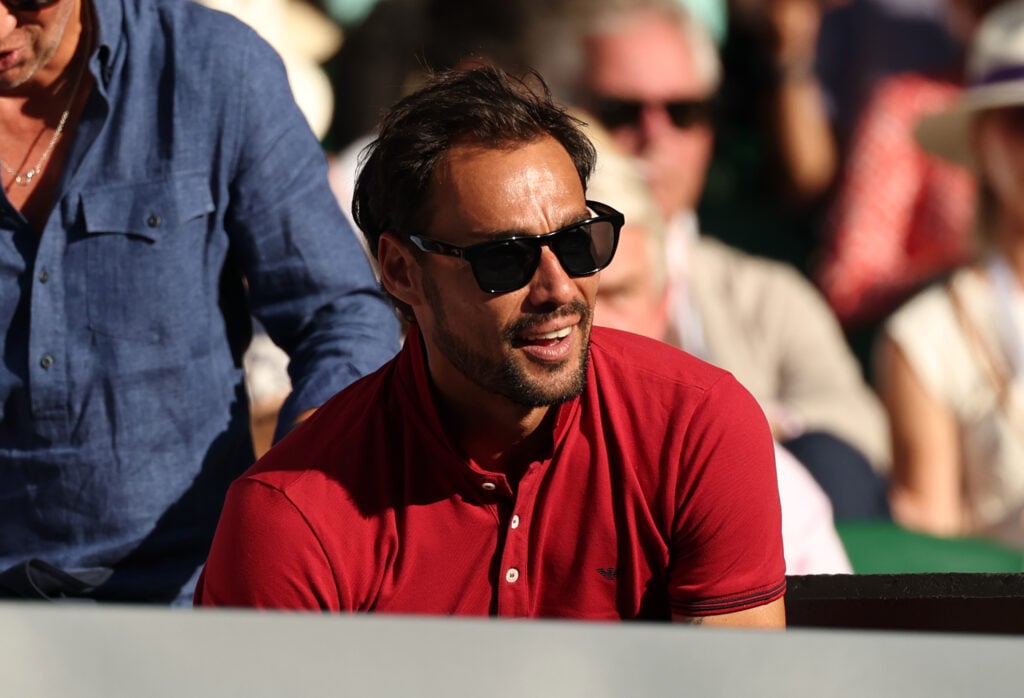 Fabio Fognini of Italy smiles from Flavio Cobolli's players box during the Gentlemen's Singles quarter-final match between Flavio Cobolli of Italy and Novak Djokovic of Serbia on day ten of The Championships Wimbledon 2025 at All England Lawn Tennis and Croquet Club.
