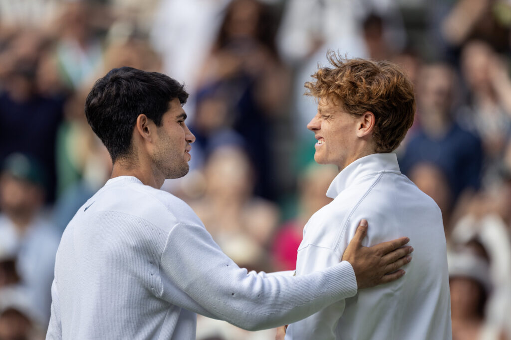 Jannik Sinner of Italy with the winners trophy is congratulated by Carlos Alcaraz of Spain, at the trophy presentations after the Gentlemen's Singles Final on Centre Court during the Wimbledon Lawn Tennis Championships at the All England Lawn Tennis and Croquet Club at Wimbledon on July 13th, 2025, in London, England.