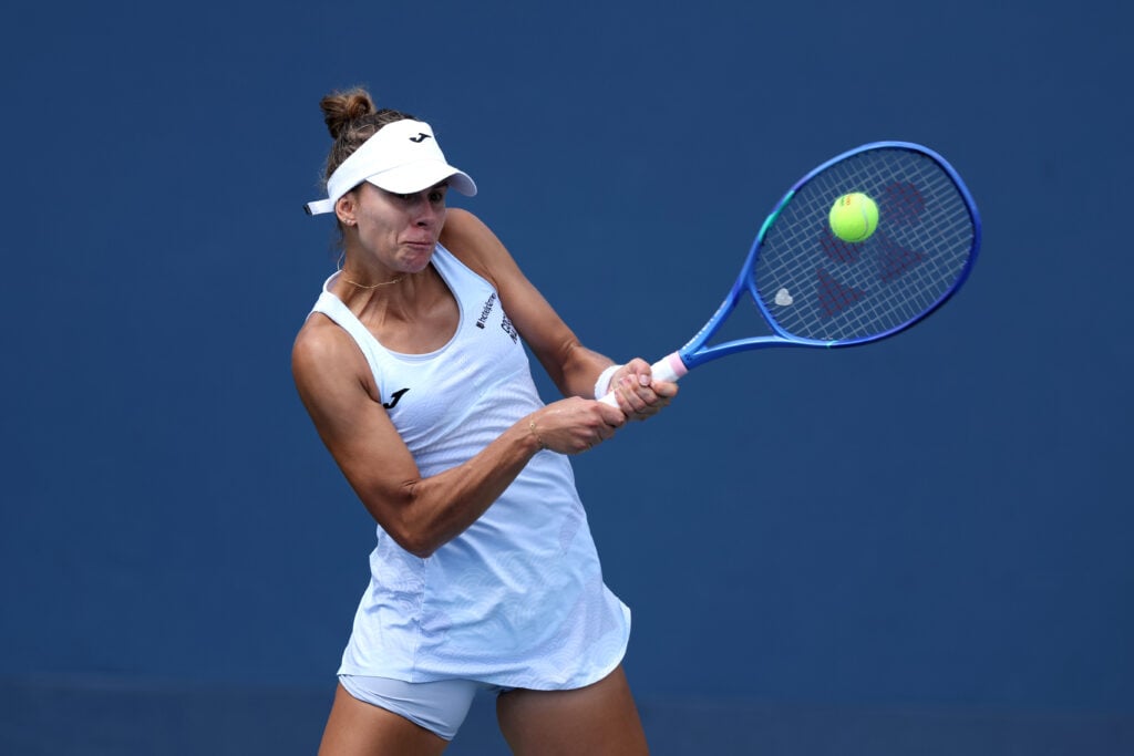 Magda Linette of Poland returns against McCartney Kessler of the United States during their Women's Singles First Round match on Day One of the 2025 US Open at USTA Billie Jean King National Tennis Center.