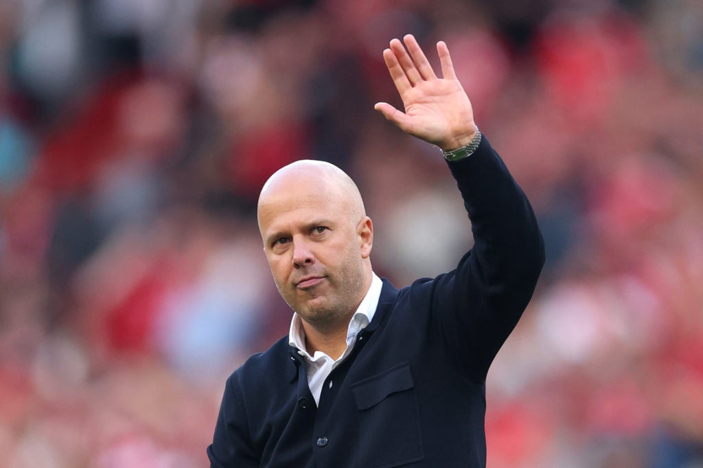 Arne Slot, Manager of Liverpool, acknowledges the fans following the team's victory during the Premier League match between Liverpool and Arsenal at Anfield.