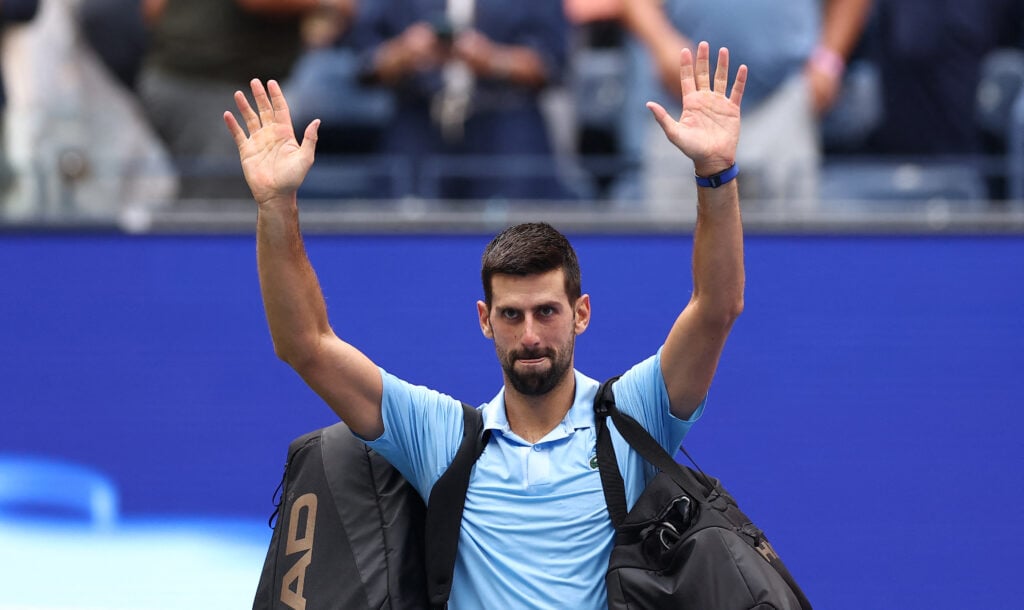 Novak Djokovic waves as he leaves the court after losing the men's singles semifinal tennis match against Spain's Carlos Alcaraz on day thirteen of the US Open tennis tournament at the USTA Billie Jean King National Tennis Center in New York City.