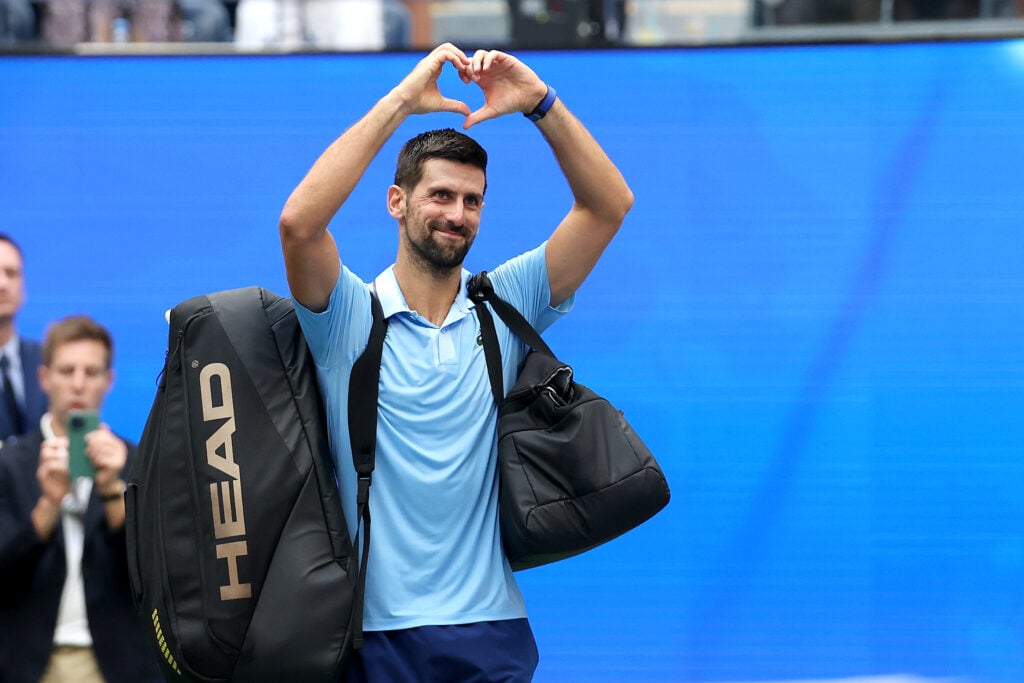 Novak Djokovic of Serbia acknowledges the crowd as he walks off the court after losing to Carlos Alcaraz of Spain during their Men's Semifinal match on Day Thirteen of the 2025 US Open at USTA Billie Jean King National Tennis Center.