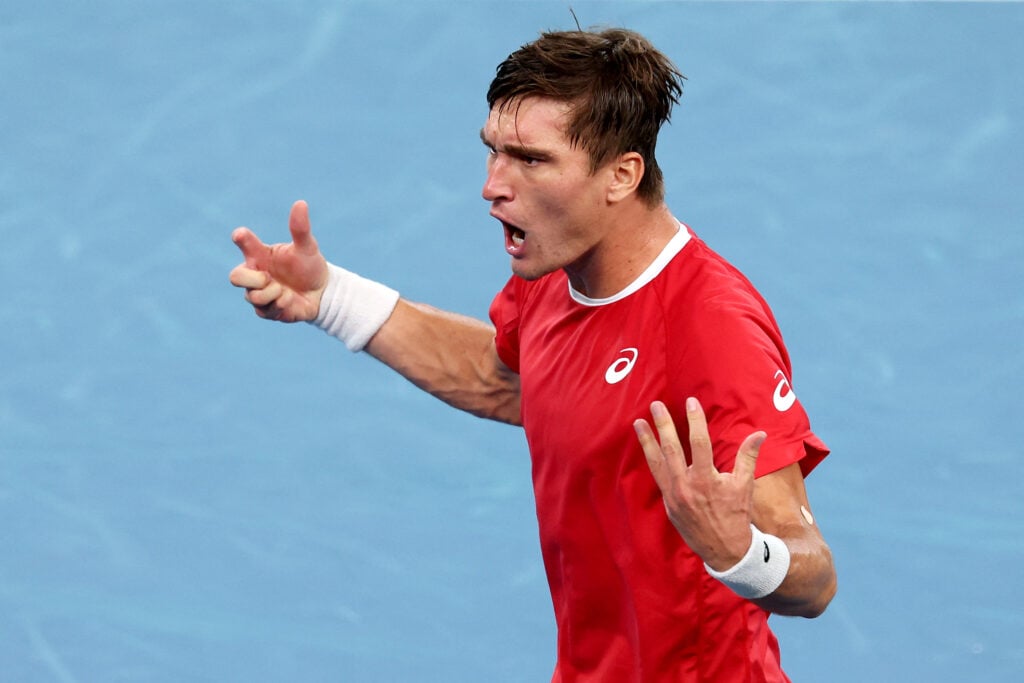 Raphael Collignon celebrates after beating Alex de Minaur at the Davis Cup
