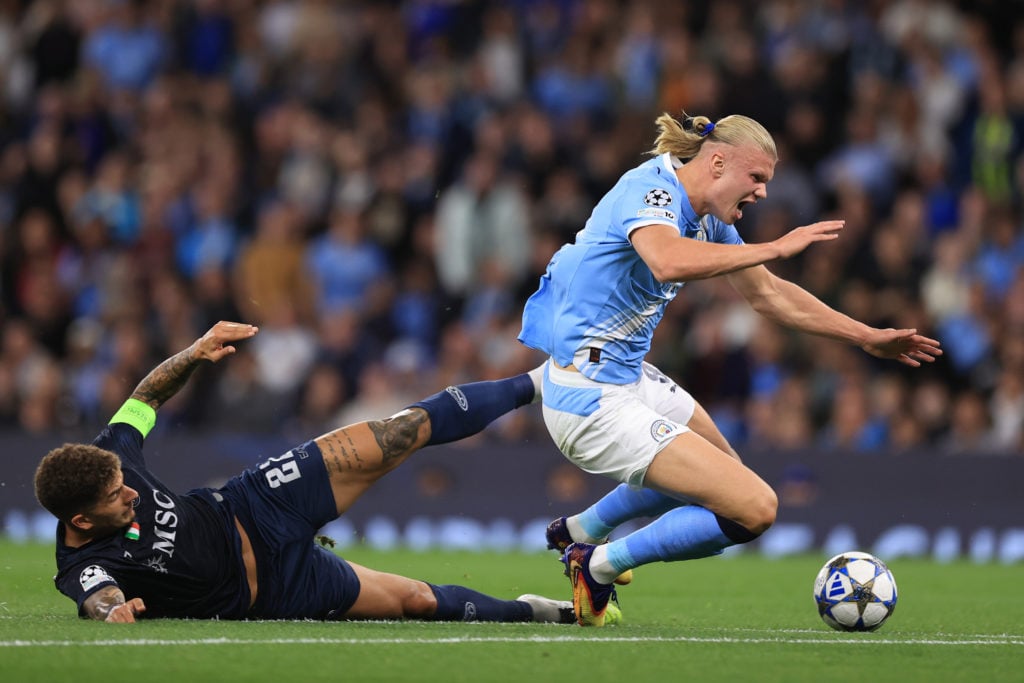 Erling Haaland being taken down during Manchester City v SSC Napoli.