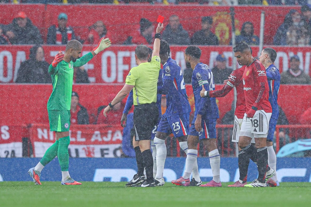Robert Sanchez of Chelsea is shown a red card by referee Peter Bankes during the Premier League match between Manchester United and Chelsea at Old Trafford.