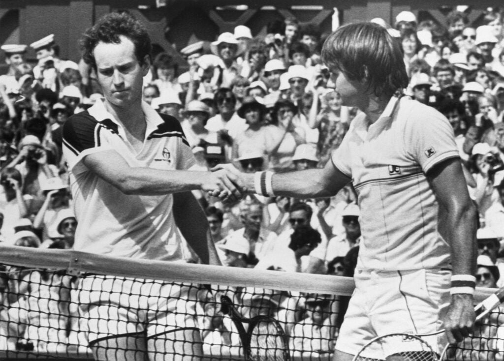 John McEnroe and Jimmy Connors shake hands after the 1984 Wimbledon final