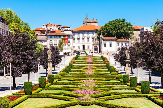 A stunning manicured garden in Guimaraes, Portugal, on a sunny day.